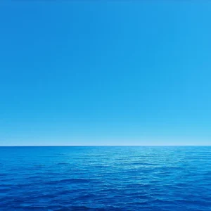 Photographie de l'horizon avec un ciel bleu parfait en haut et une mer calme bleu en bas